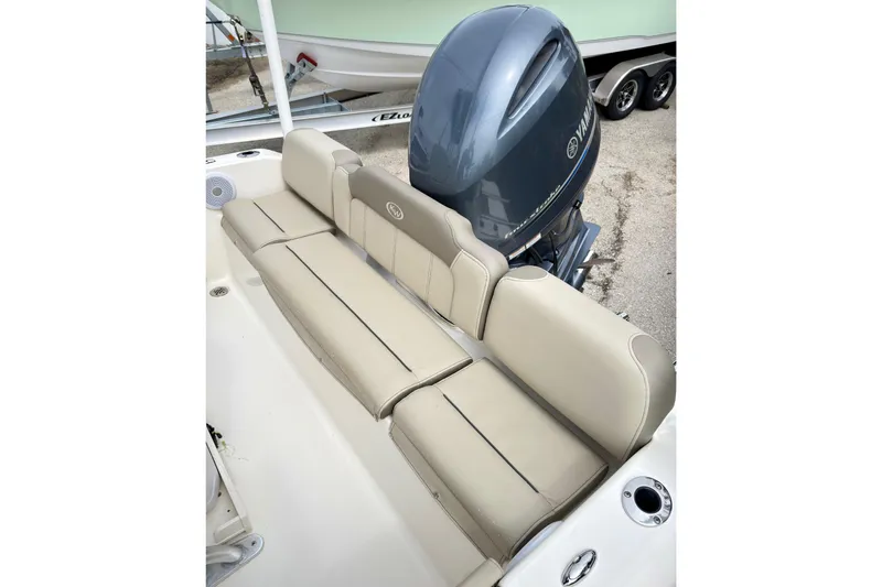 Slide: The Image of 2023 Key West 189 FS boat with beige seating and Yamaha outboard motor. - 6