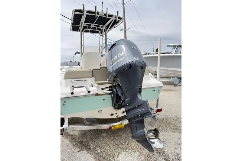 Slide: The Image of 2023 Key West 189 FS boat with Yamaha outboard motor, parked on a trailer. - 9