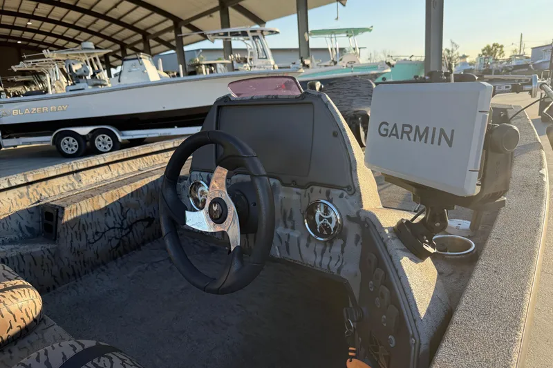 Slide: The Image of 2019 Xpress XP7 boat interior with Garmin navigation system and steering wheel. - 10