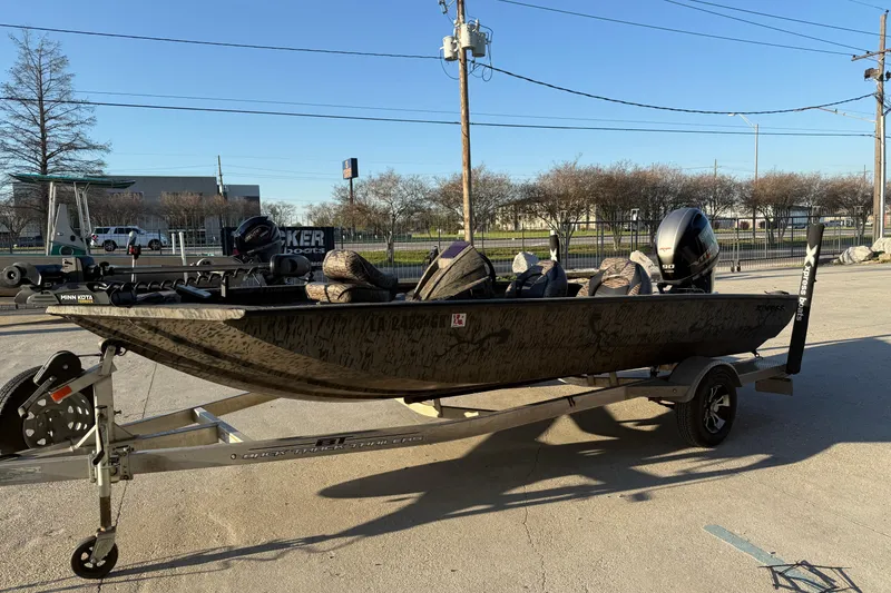 Slide: The Image of 2019 Xpress XP7 boat on trailer, parked outdoors, with motor and accessories. - 4
