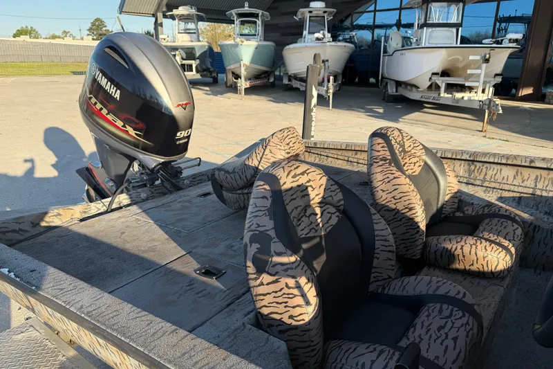Slide: The Image of 2019 Xpress XP7 boat with Yamaha engine, camo seats, and other boats in the background. - 9