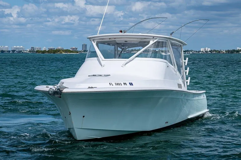 Slide: The Image of 2012 Brooks Boatworks 34 cruising on blue waters under a partly cloudy sky. - 1