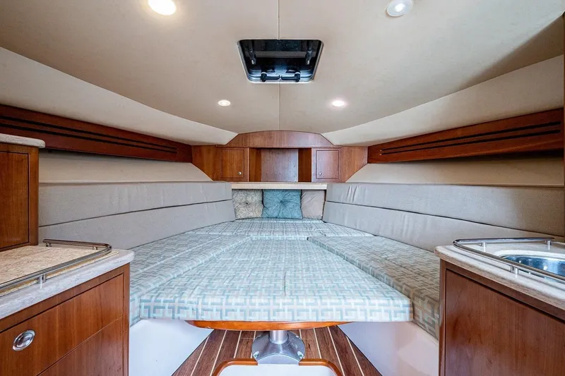 Slide: The Image of Luxurious interior of 2012 Brooks Boatworks 34, featuring cozy bedding and elegant wood finishes. - 11