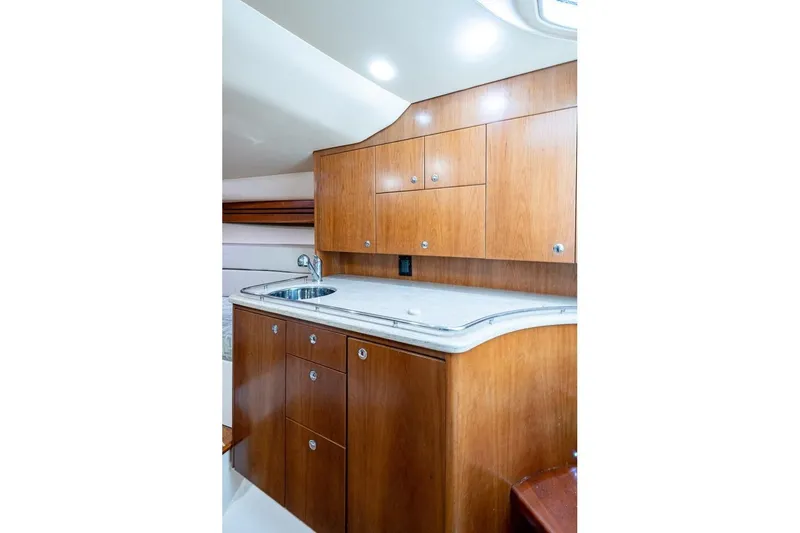 Slide: The Image of Luxurious wooden interior of 2012 Brooks Boatworks 34, featuring a sleek kitchenette design. - 15