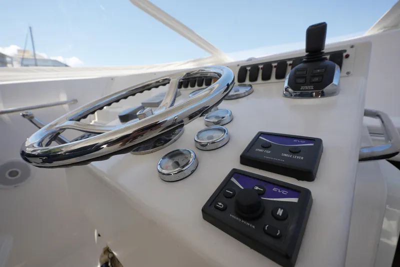 Slide: The Image of Steering console of 2012 Custom Carolina 34 boat with controls and gauges. - 18