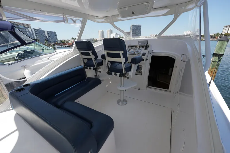 Slide: The Image of Interior view of a 2012 Custom Carolina 34 boat with seating and helm. - 19