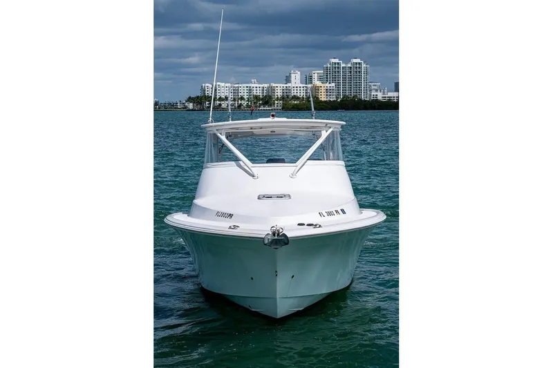 Slide: The Image of Front view of a 2012 Brooks Boatworks 34 on water, with city skyline background. - 2