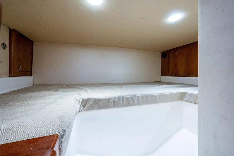 Slide: The Image of Cozy cabin interior of 2012 Brooks Boatworks 34 with wooden storage compartments. - 24