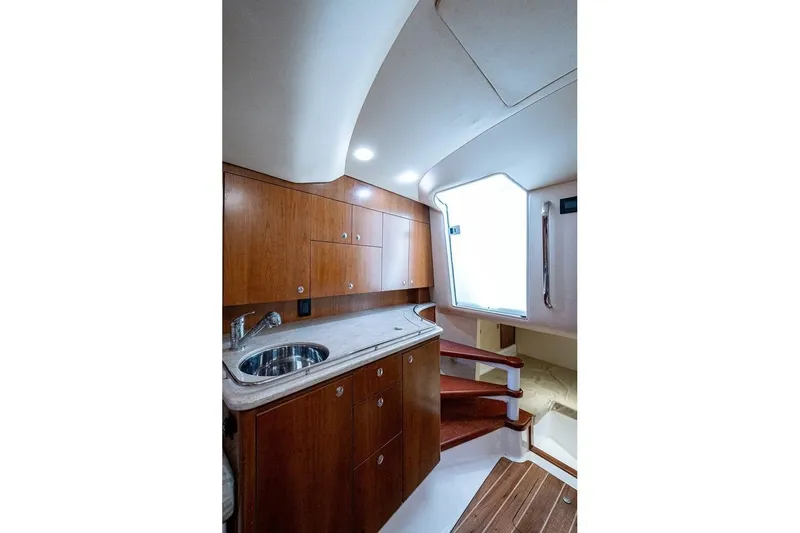 Slide: The Image of Luxurious interior of 2012 Brooks Boatworks 34, featuring wooden cabinetry and modern fixtures. - 25