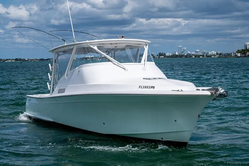 Slide: The Image of 2012 Brooks Boatworks 34 cruising on open water under a cloudy sky. - 3