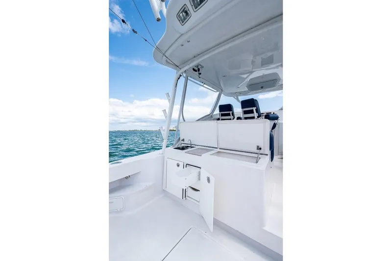 Slide: The Image of 2012 Brooks Boatworks 34 interior with open storage, ocean view, and seating. - 7