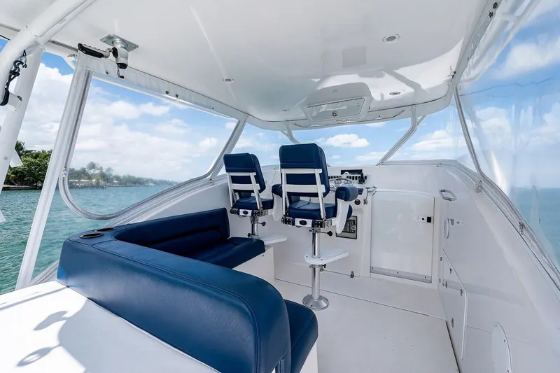 Slide: The Image of Interior of 2012 Brooks Boatworks 34, featuring blue seating and helm, with ocean view. - 8