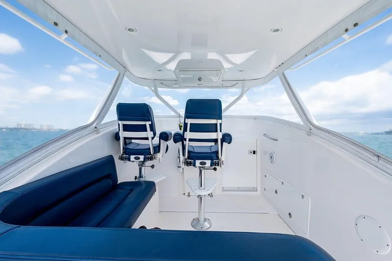 Slide: The Image of Interior of 2012 Brooks Boatworks 34, featuring blue seating and ocean view. - 9