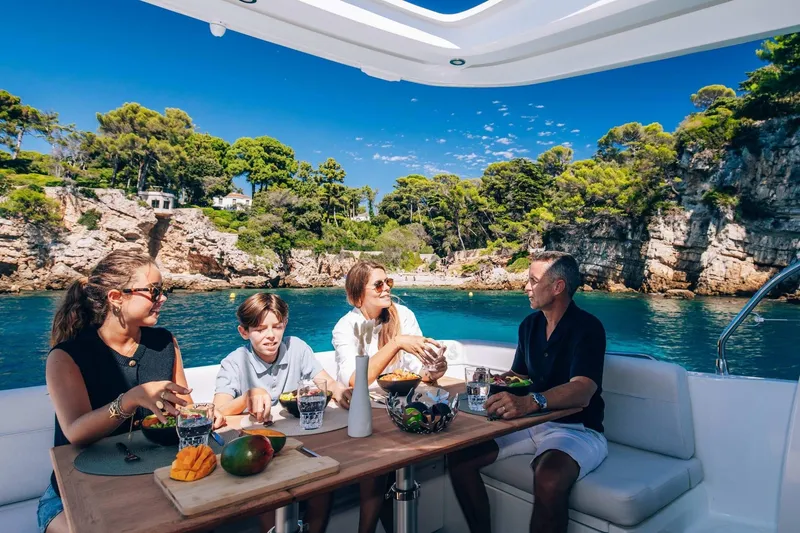 Slide: The Image of Family enjoying meal on Beneteau Antares 12 Coupe 2026. - 4