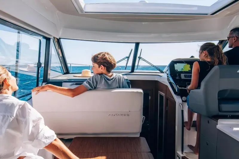 Slide: The Image of Family enjoying a boat ride on Beneteau Antares 12 Coupe 2026. - 6
