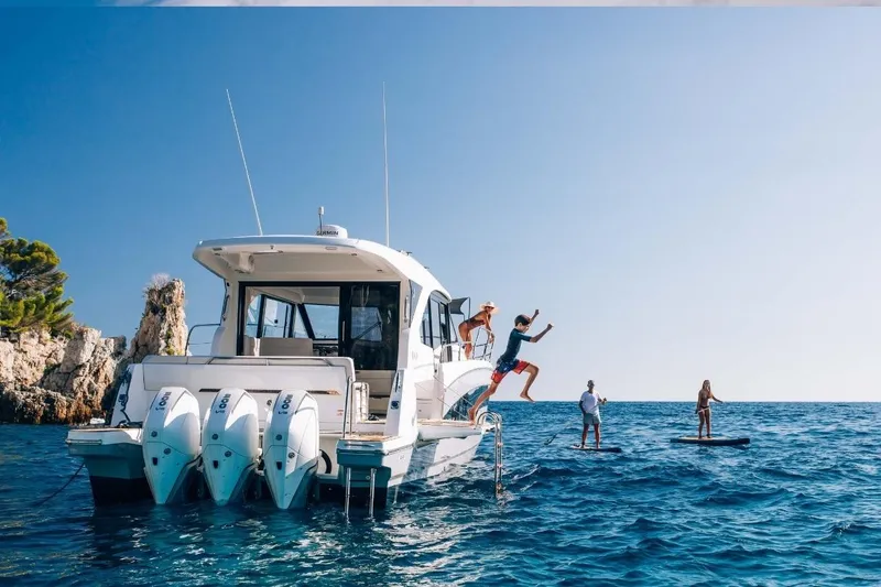 Slide: The Image of 2026 Beneteau Antares 12 Coupe with people enjoying water activities. - 7