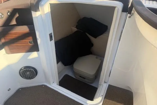 Slide: The Image of 2015 Cobalt R5 boat interior with storage compartment and portable toilet. - 15