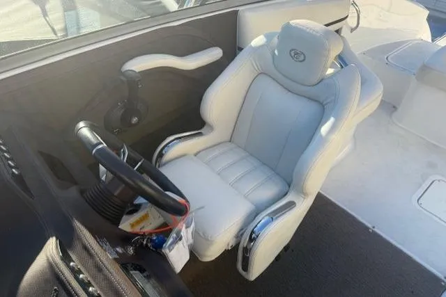 Slide: The Image of Captain's seat and steering wheel of a 2015 Cobalt R5 boat, featuring luxurious white upholstery. - 18
