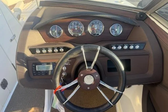 Slide: The Image of Steering wheel and dashboard of a 2015 Cobalt R5 boat with gauges and controls. - 20