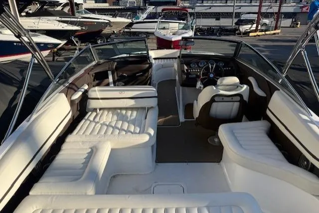 Slide: The Image of Interior of a 2015 Cobalt R5 boat with white seating and dashboard view. - 27