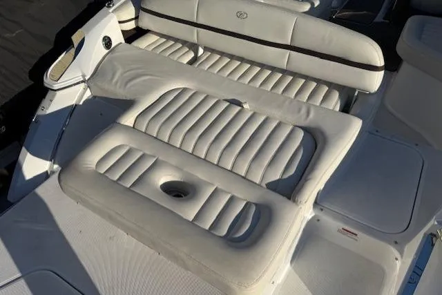 Slide: The Image of 2015 Cobalt R5 boat interior with white cushioned seating and sleek design. - 28