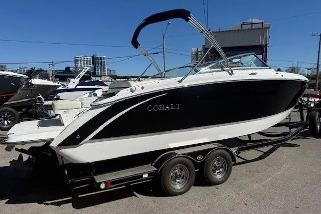 Slide: The Image of 2015 Cobalt R5 boat on trailer, black and white design, parked outdoors. - 3