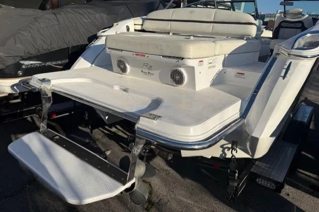 Slide: The Image of 2015 Cobalt R5 boat with swim platform and seating area, docked outdoors. - 32