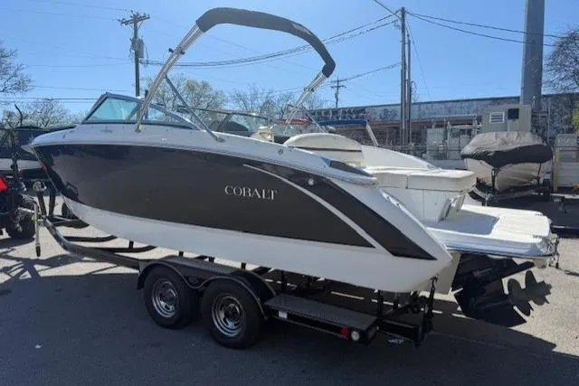 Slide: The Image of 2015 Cobalt R5 boat on trailer, parked outdoors under clear sky. - 5