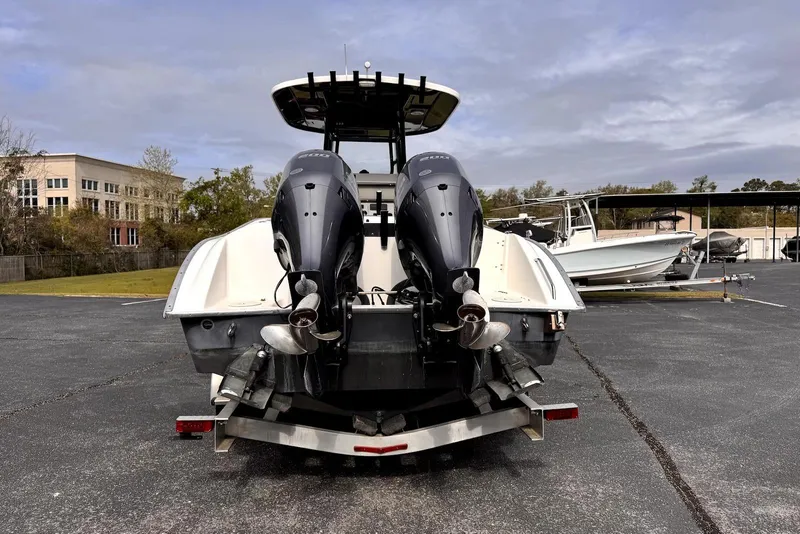 Slide: The Image of 2020 Cape Horn 27 XS boat with dual engines on a trailer in a parking lot. - 10