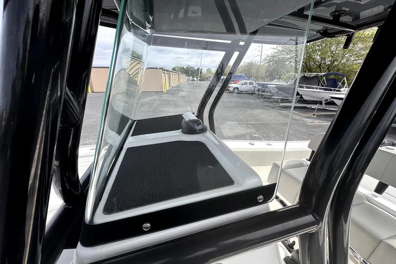 Slide: The Image of 2020 Cape Horn 27 XS boat console with glass windshield and black frame. - 14