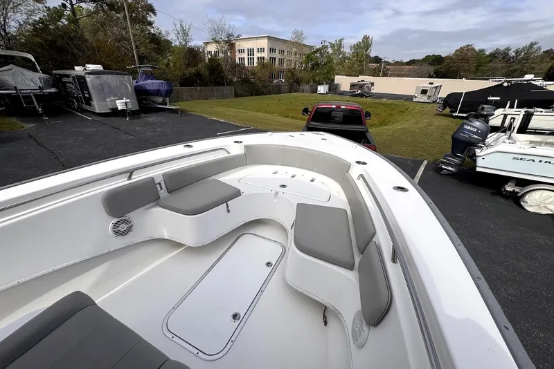 Slide: The Image of 2020 Cape Horn 27 XS boat with spacious seating, parked outdoors near other boats. - 16