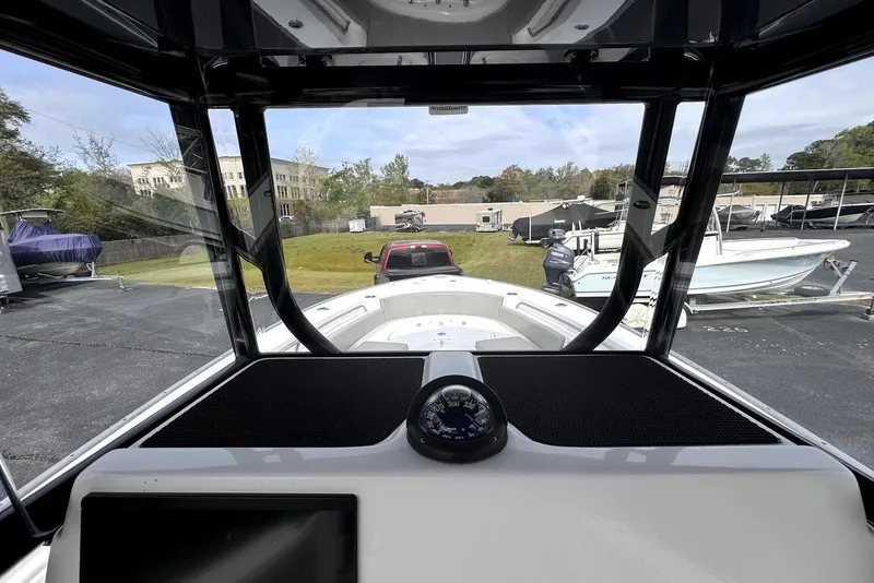 Slide: The Image of Interior view of 2020 Cape Horn 27 XS boat, showcasing dashboard and compass. - 22