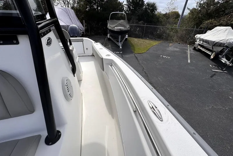 Slide: The Image of 2020 Cape Horn 27 XS boat parked in a lot, showcasing sleek design and seating. - 24