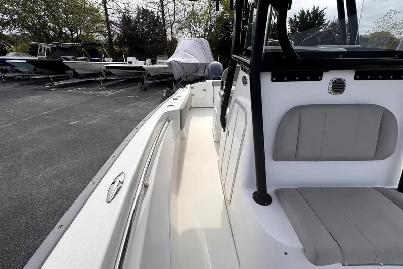 Slide: The Image of 2020 Cape Horn 27 XS boat interior with seating, parked among other boats. - 25