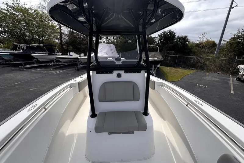 Slide: The Image of 2020 Cape Horn 27 XS boat interior with seating and console, parked outdoors. - 30