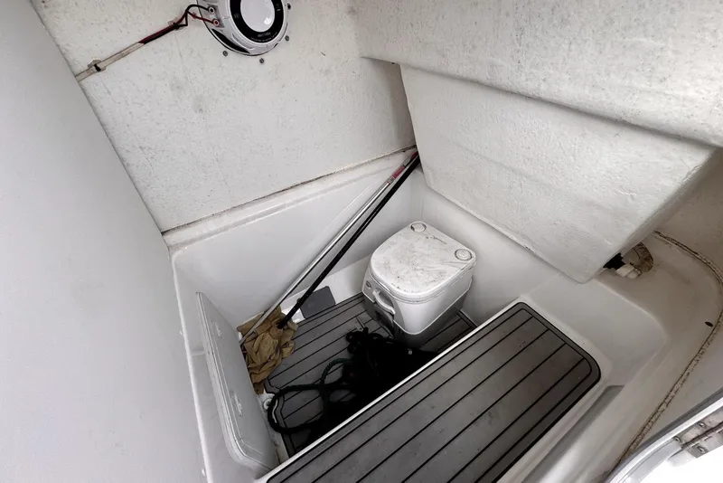 Slide: The Image of Interior of 2020 Cape Horn 27 XS boat featuring compact marine toilet setup. - 32