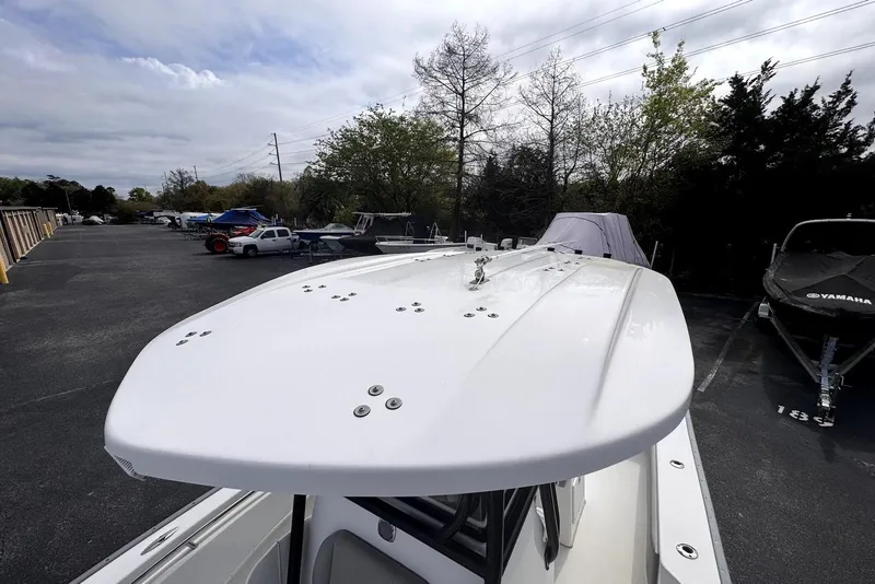 Slide: The Image of 2020 Cape Horn 27 XS boat in parking lot, surrounded by trees and vehicles. - 33