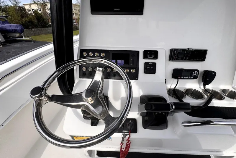 Slide: The Image of 2020 Cape Horn 27 XS boat dashboard with steering wheel and control panel. - 36