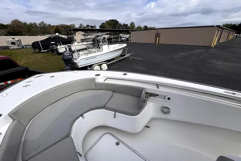 Slide: The Image of 2020 Cape Horn 27 XS boat interior with seating, parked near storage units. - 39