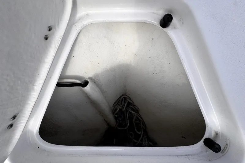 Slide: The Image of Storage compartment of a 2020 Cape Horn 27 XS boat with coiled rope inside. - 40