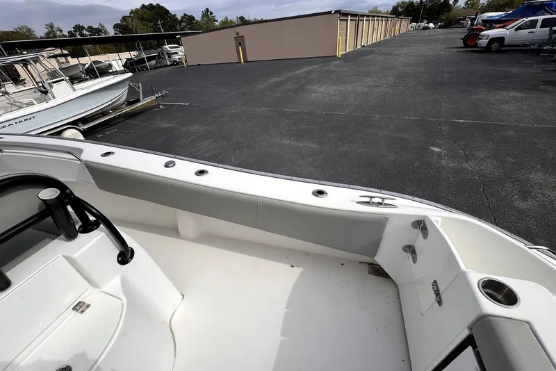 Slide: The Image of 2020 Cape Horn 27 XS boat interior at storage facility, showcasing seating and deck layout. - 41
