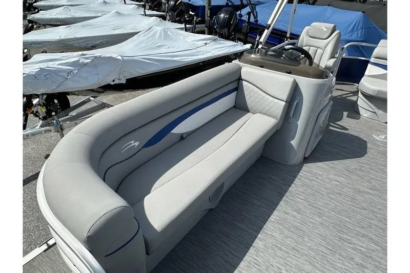 Slide: The Image of 2023 Bennington 20 SVL pontoon boat interior with plush seating and steering console. - 12