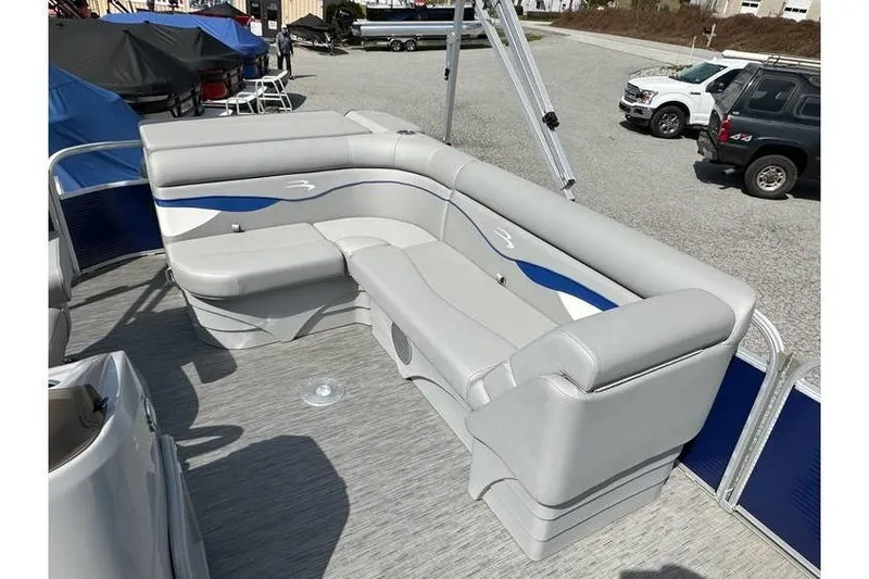 Slide: The Image of 2023 Bennington 20 SVL pontoon boat interior with gray seating and blue accents. - 14