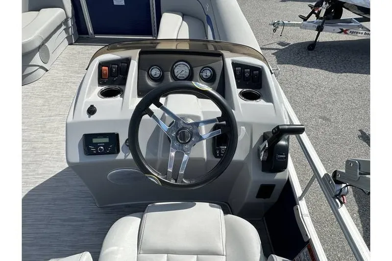 Slide: The Image of 2023 Bennington 20 SVL boat dashboard with steering wheel and controls. - 16