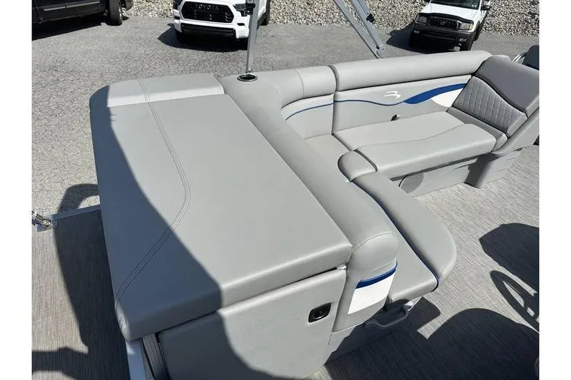Slide: The Image of 2023 Bennington 20 SVL boat interior with gray seating and blue accents. - 18