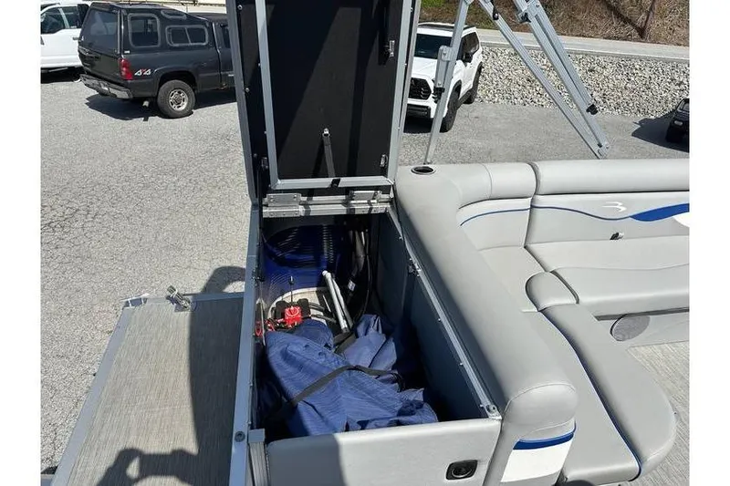 Slide: The Image of 2023 Bennington 20 SVL boat storage compartment open, showing interior contents. - 19