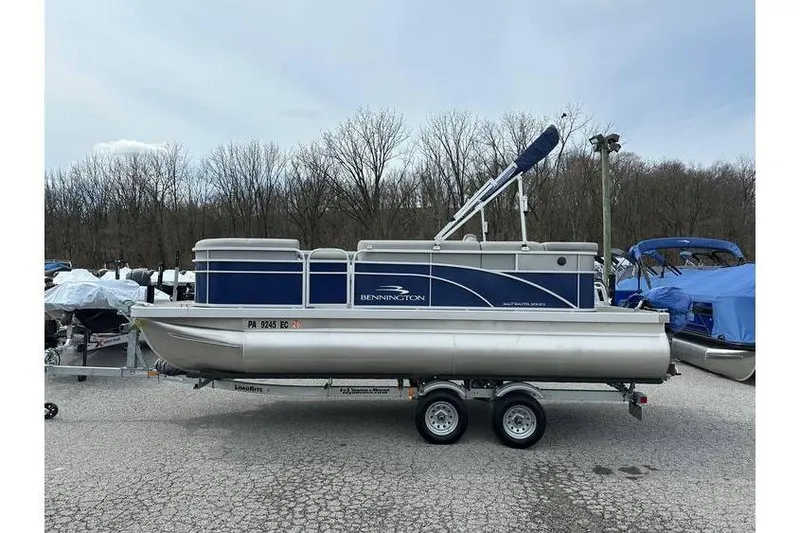 Slide: The Image of 2023 Bennington 20 SVL pontoon boat with Yamaha 25Hp engine on tandem axle trailer. - 6