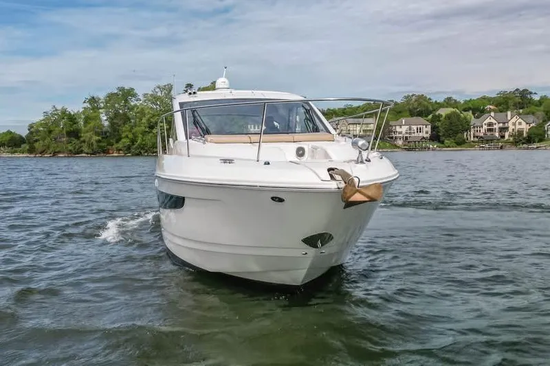 Slide: The Image of 2017 Sea Ray Sundancer 350 Coupe cruising on a scenic lake. - 11