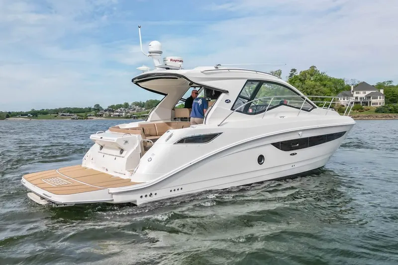 Slide: The Image of 2017 Sea Ray Sundancer 350 Coupe cruising on a scenic waterway. - 12