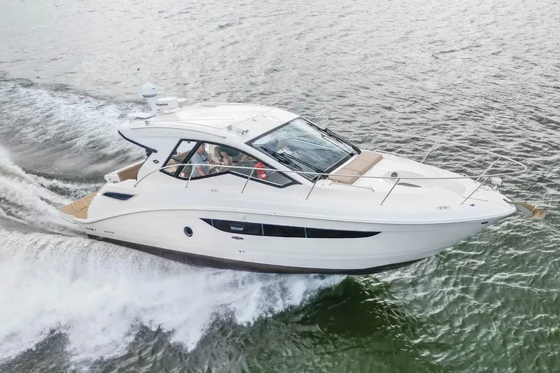 Slide: The Image of 2017 Sea Ray Sundancer 350 Coupe cruising on open water. - 14